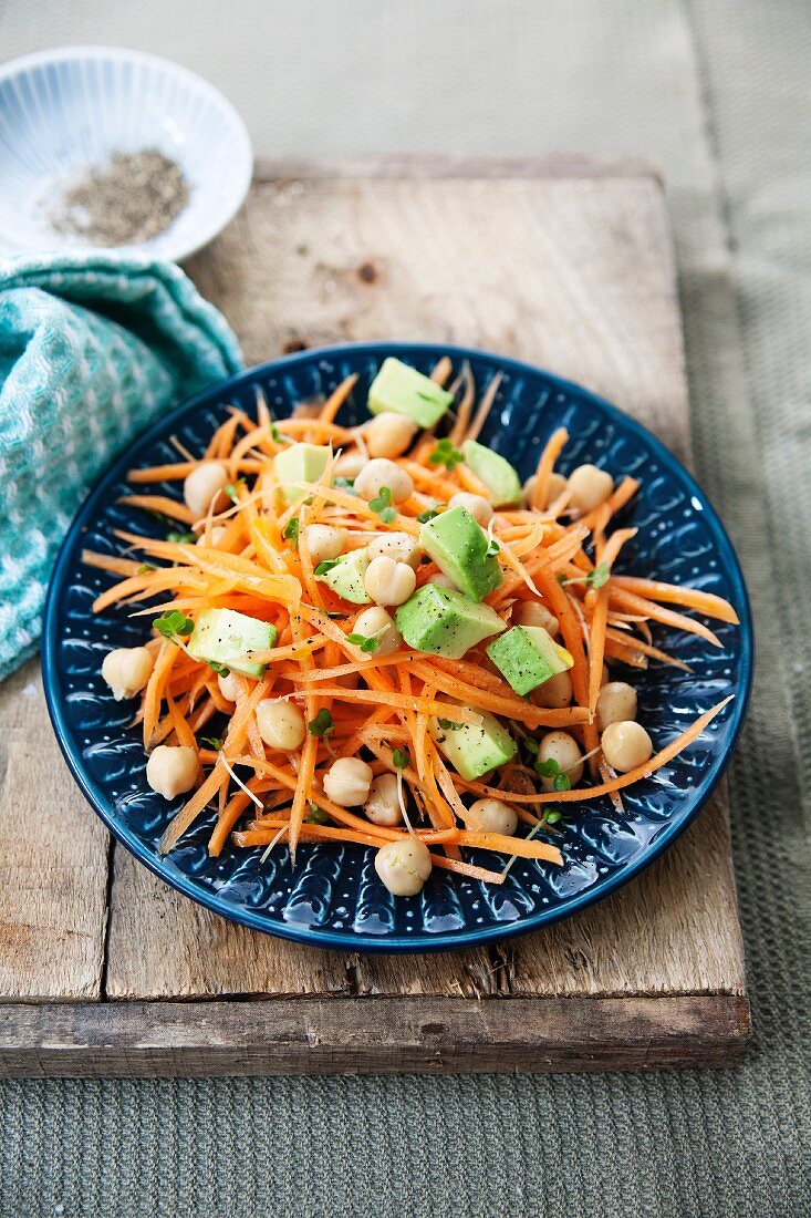 A healthy carrot salad with chickpeas, avocado and lemon