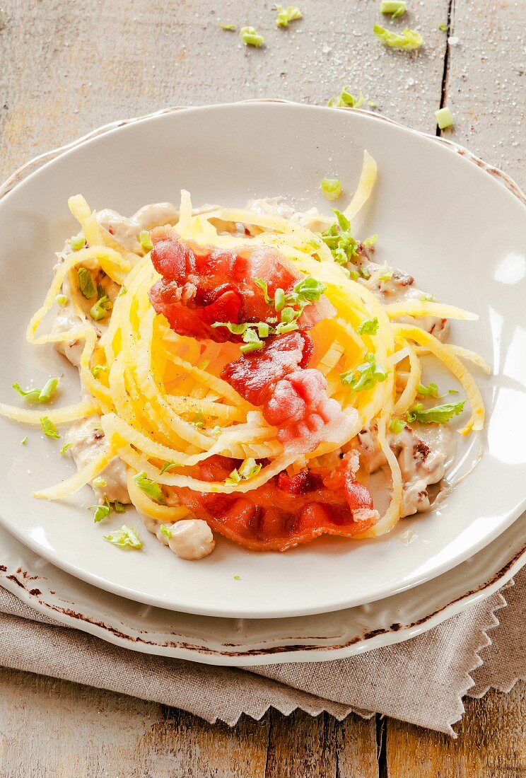Turnip spaghetti with bacon and cheese sauce