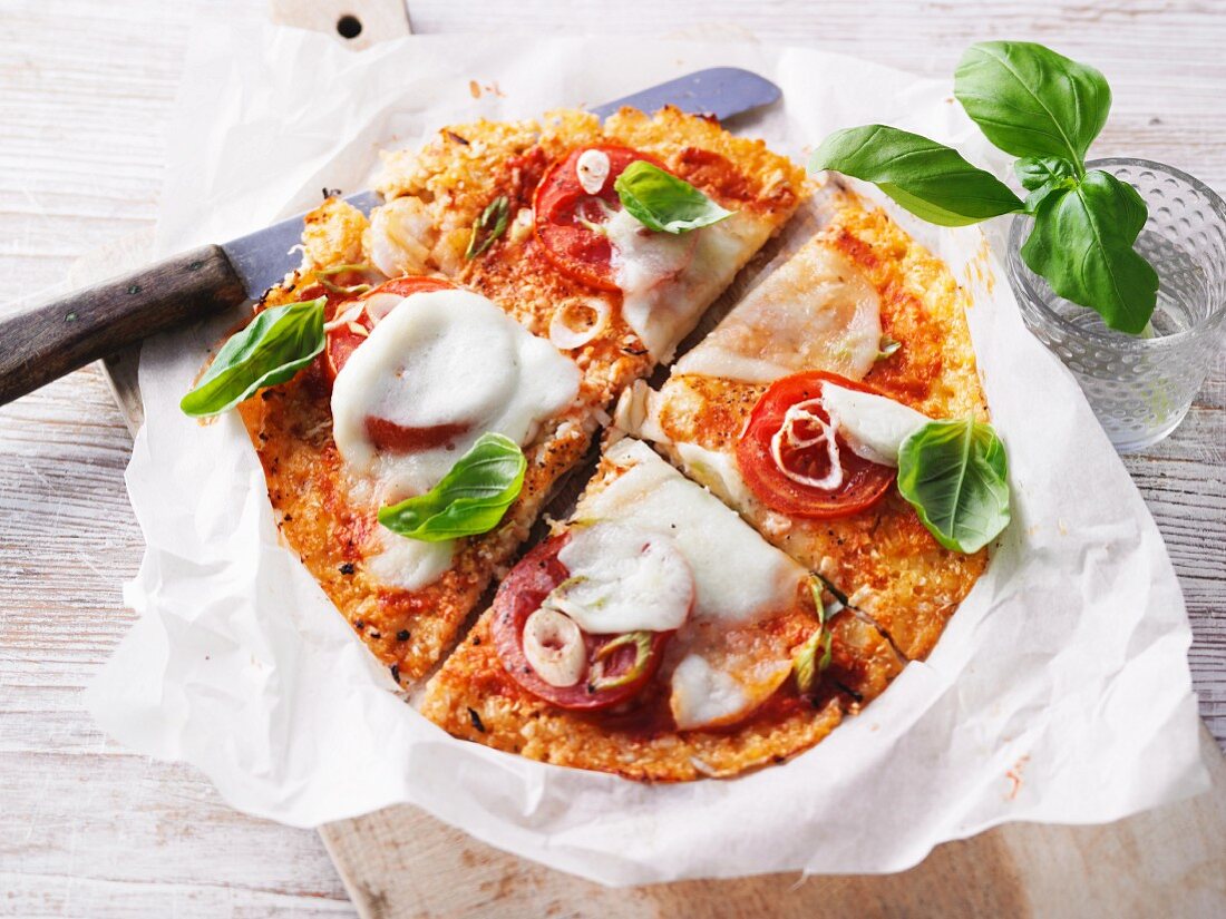 Low carb pizza with cauliflower cheese base, tomatoes and mozzarella