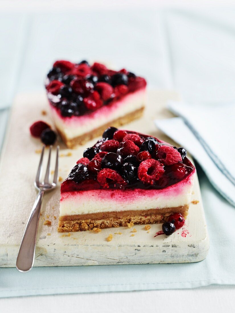 Two slices of berry cheesecake