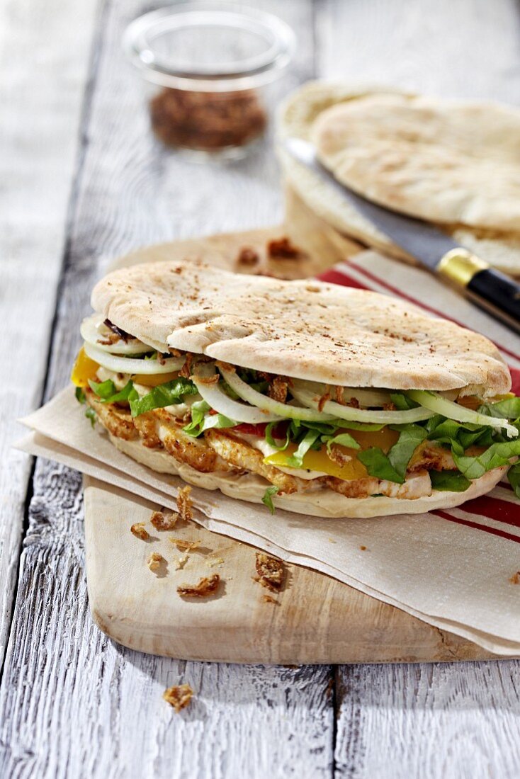 A flatbread sandwich with houmous and chicken