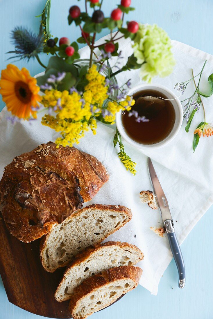 Spelt bread, tea and a bunch of flowers