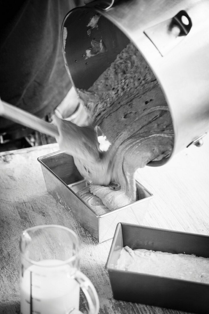 Filling a baking tray with bread dough