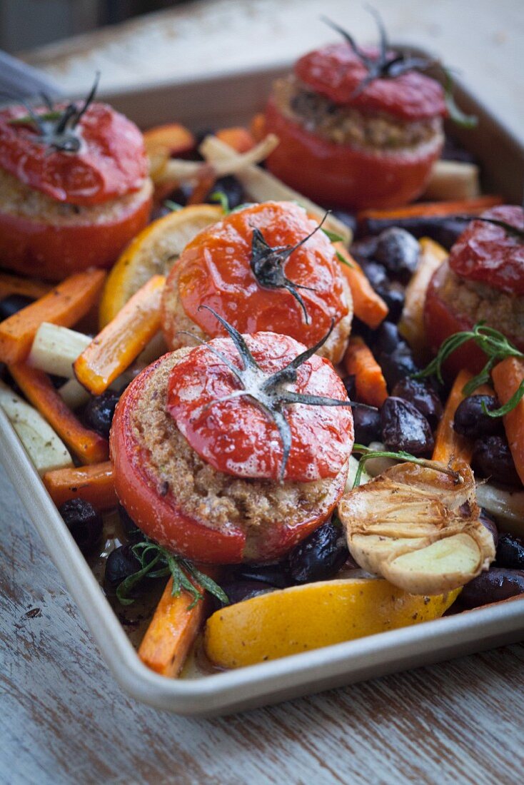 Tomatoes stuffed with amaranth and vegan cheese with root vegetables