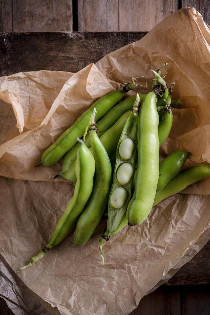 Broad beans on brown paper