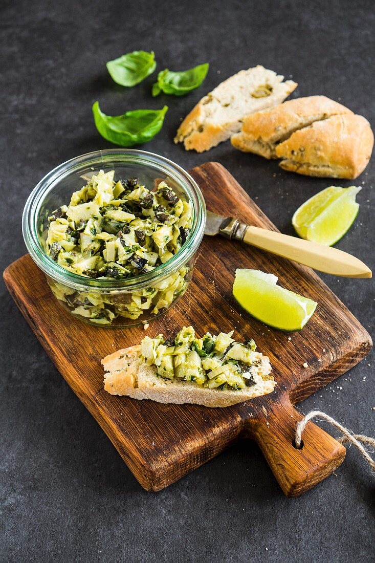 Artichoke and olive tapenade with wedges of lime and bread