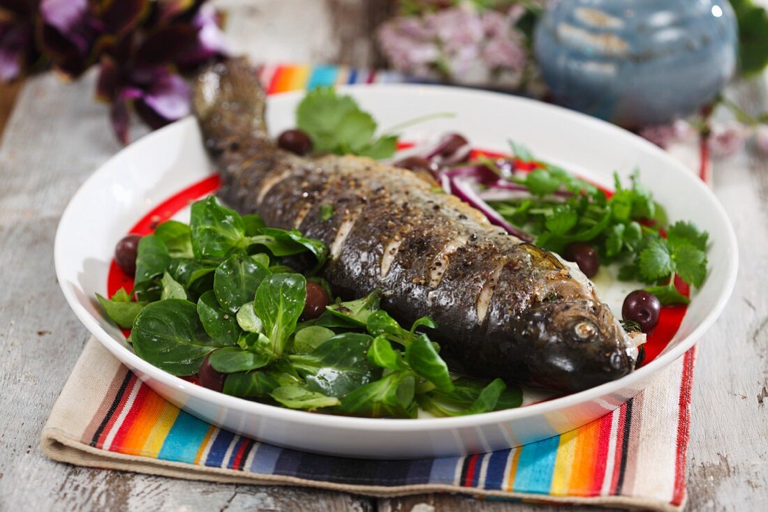 Oven-baked trout with lamb's lettuce and olives