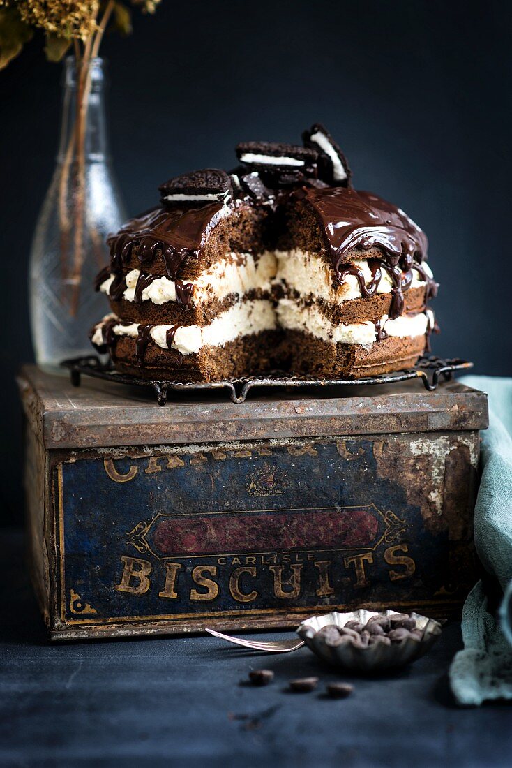 Chocolate cream cake with chocolate biscuits on an old biscuit tin