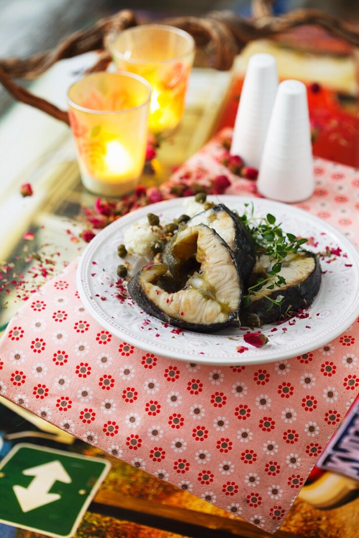 Sturgeon steaks with capers and fresh herbs