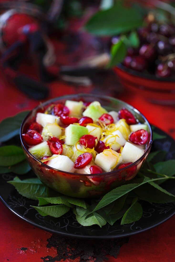Fruit salad with melon, apple, cherries and lemon