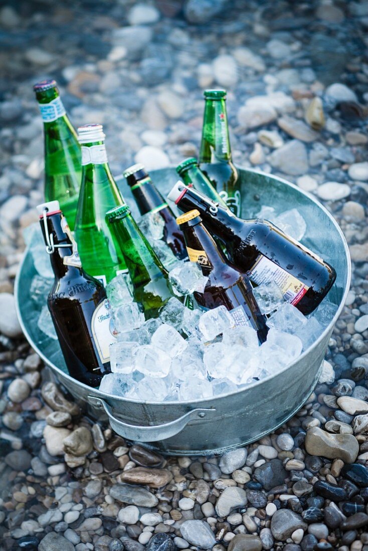 Beer and mineral water bottles in an ice bucket