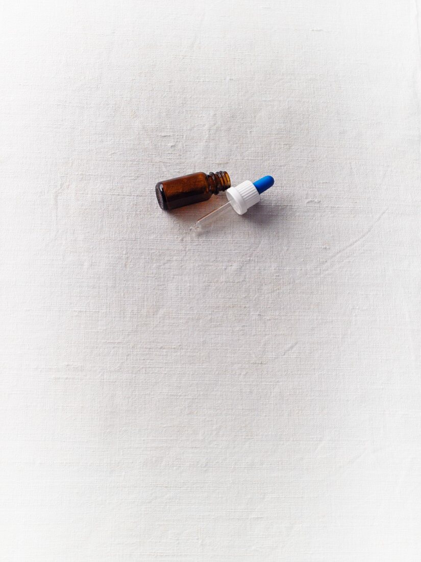 A pipette bottle on a white surface