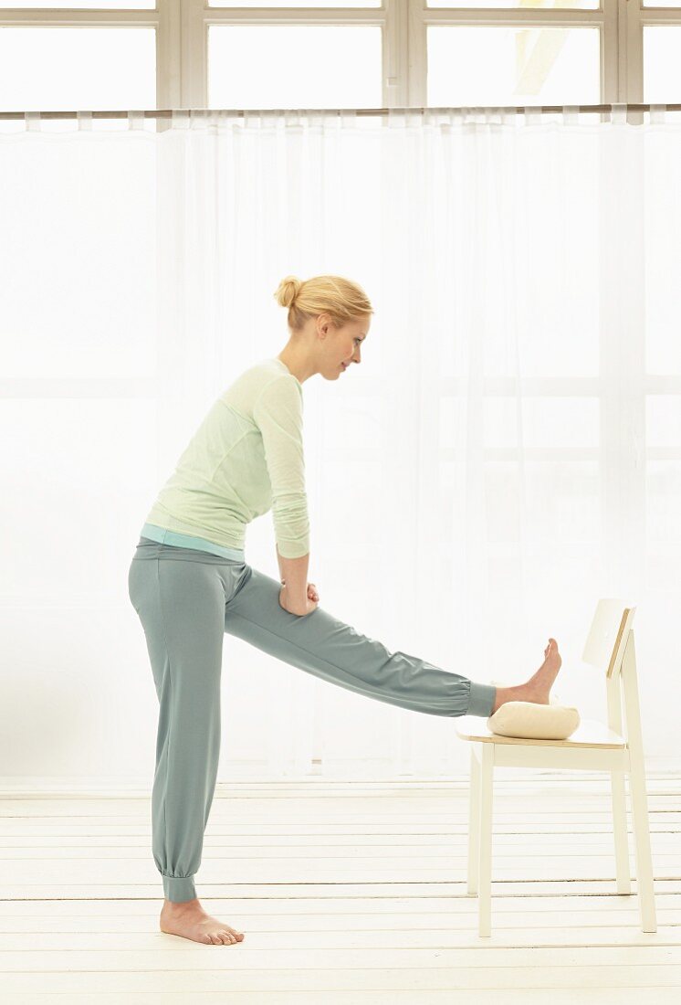 Stretching exercise with a chair