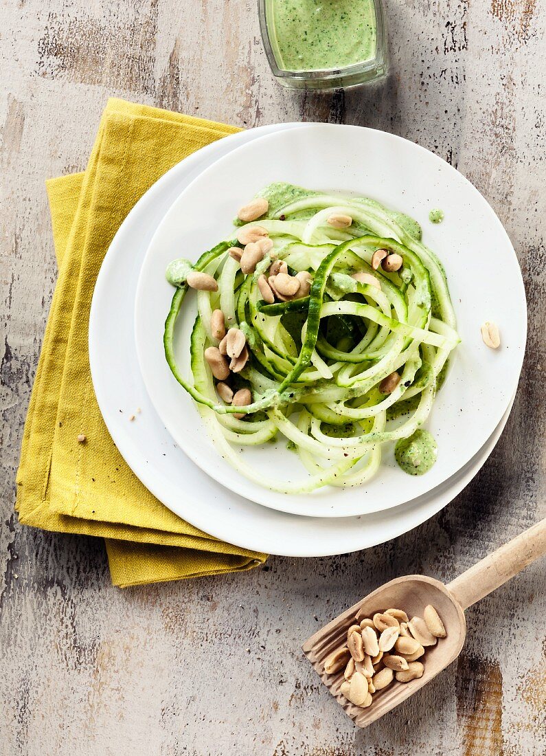 Cucumber vegetable spaghetti with a spinach and peanut sauce