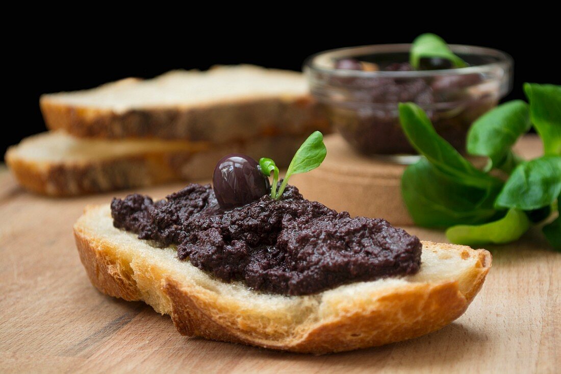 Olive paste on a slice of bread