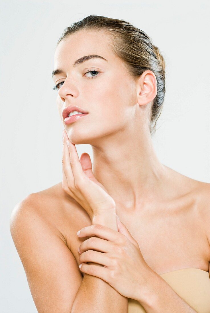 A young woman performing skincare