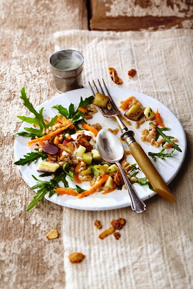 A partially eaten spelt and apple salad