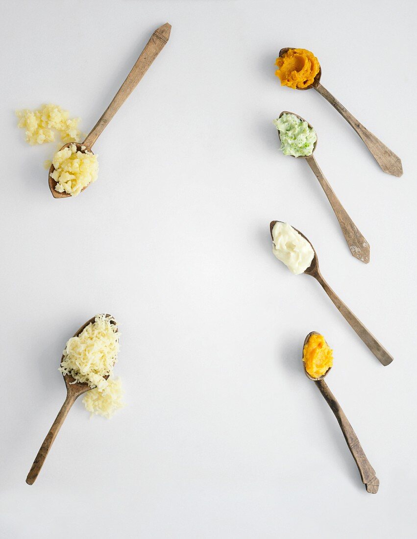 Mashed potatoes with various ingredients on spoons