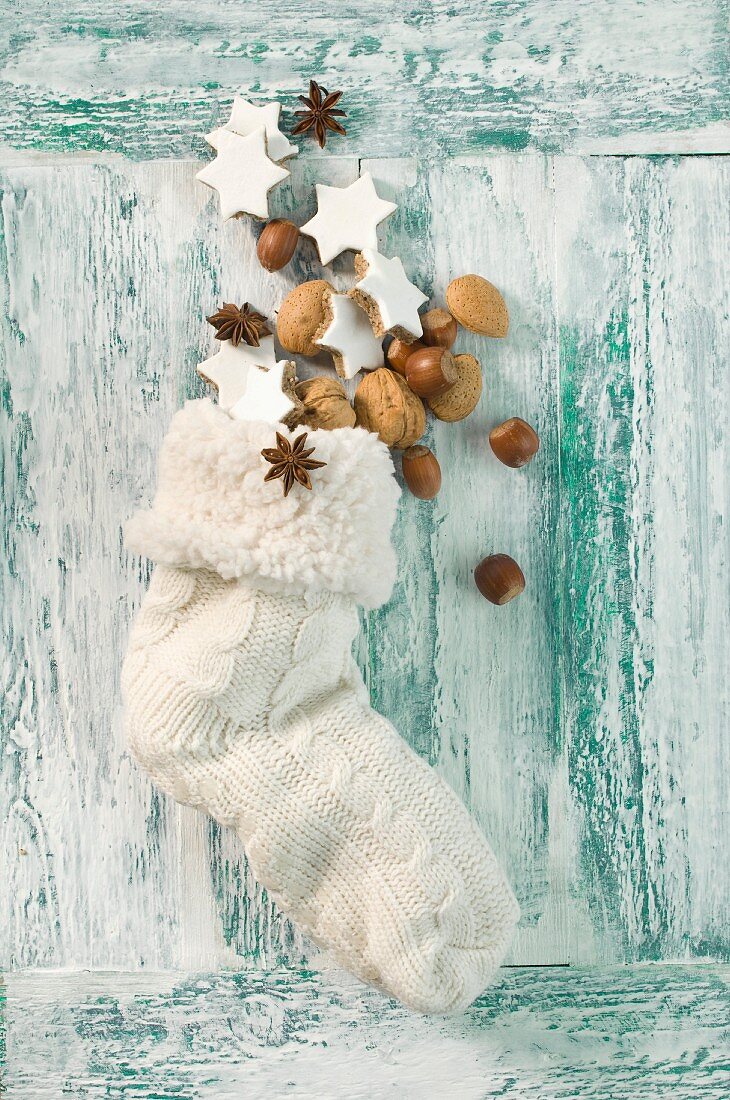 Cinnamon stars, nuts and anise starts in a Christmas stocking