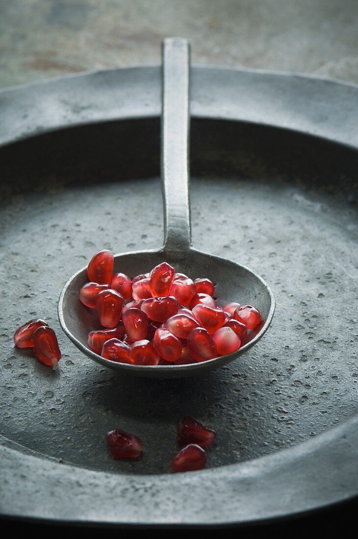 Pomegranate seed on a spoon (close-up)