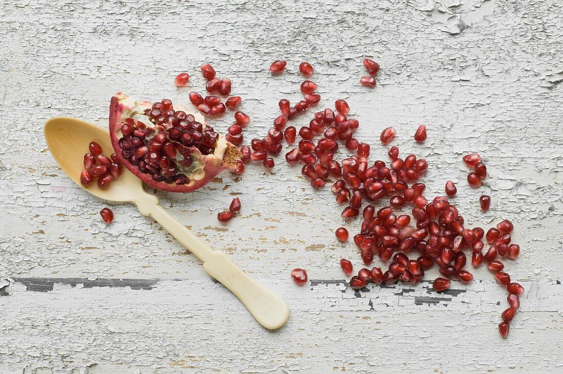 A pomegranate wedge and pomegranate seeds