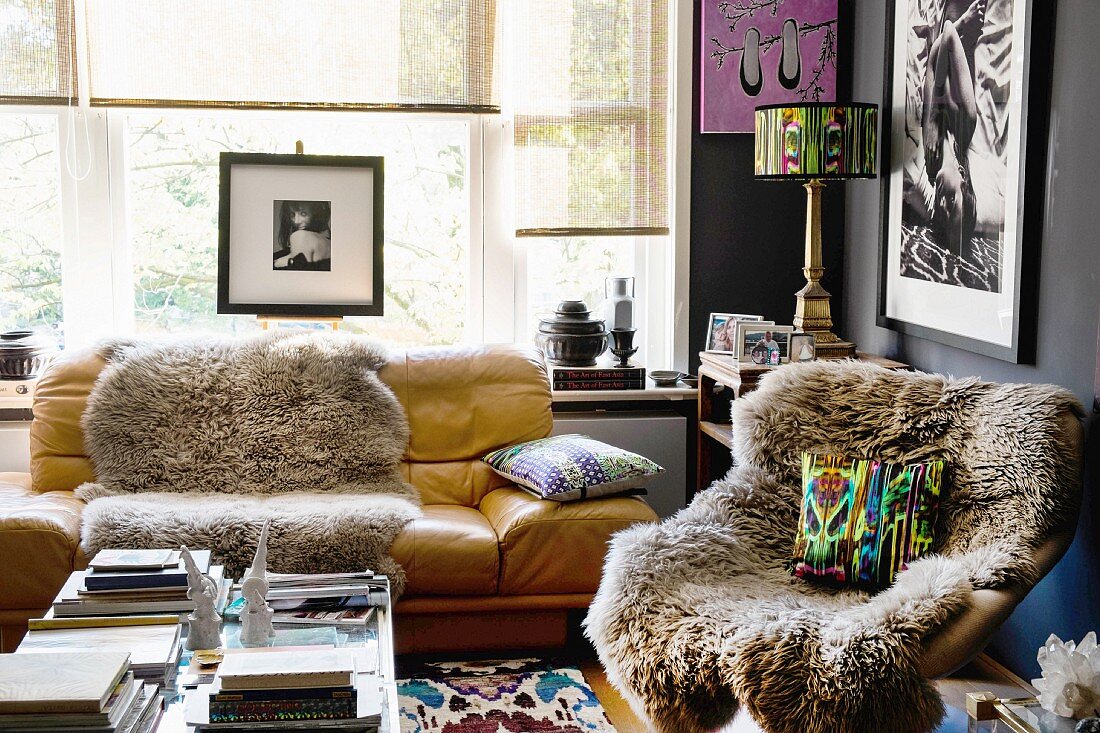 Sheepskin rugs on easy chair and sofa in artistic living room