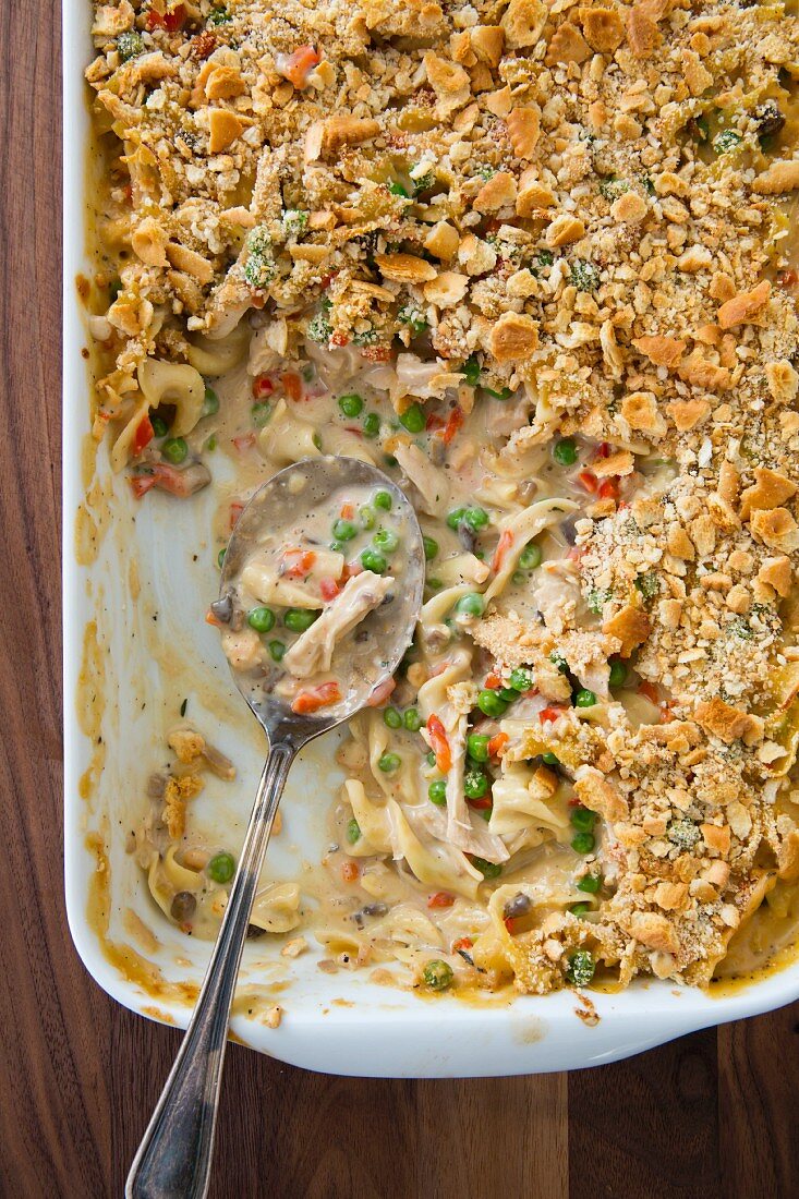 Pasta bake with chicken in a baking dish, sliced