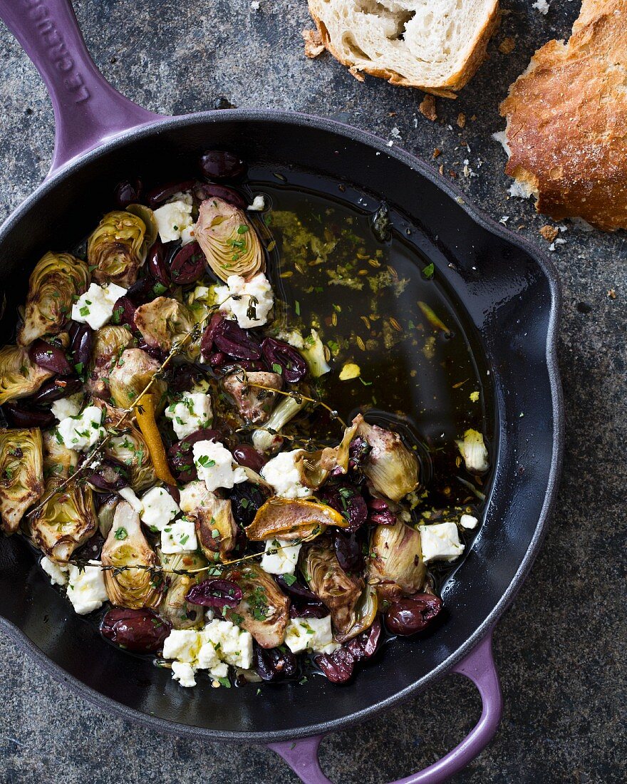 Warm marinated artichoke hearts with olive oil, Kalamata olives, thyme and feta cheese