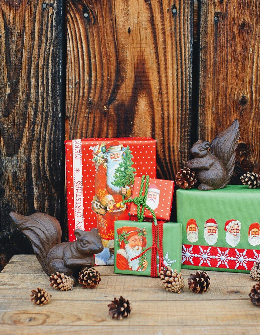 Gifts wrapped creatively in paper with Father Christmas motifs and metal squirrels