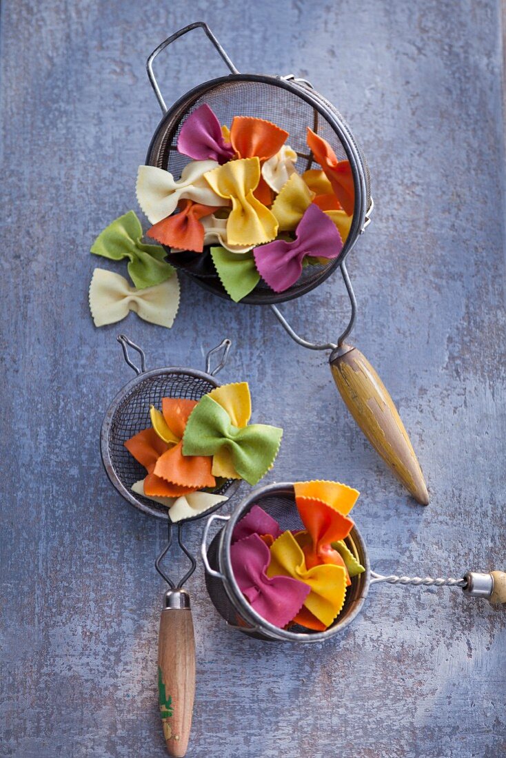 Colorful farfalle pasta in a colander