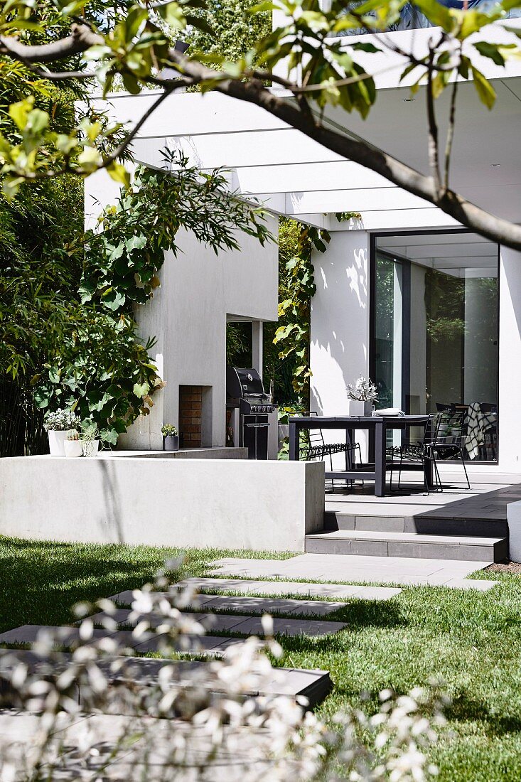 Garden path to the modern house with terrace and pergola