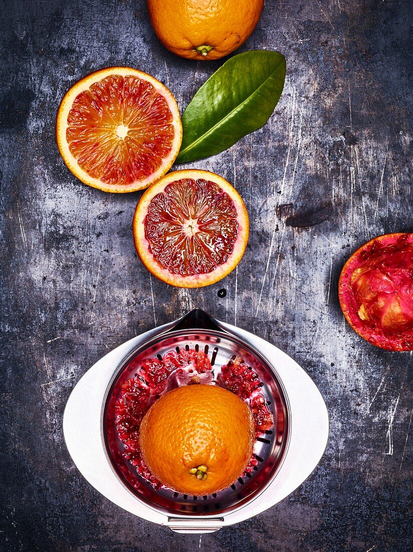 Blood oranges with a stainless steel juicer