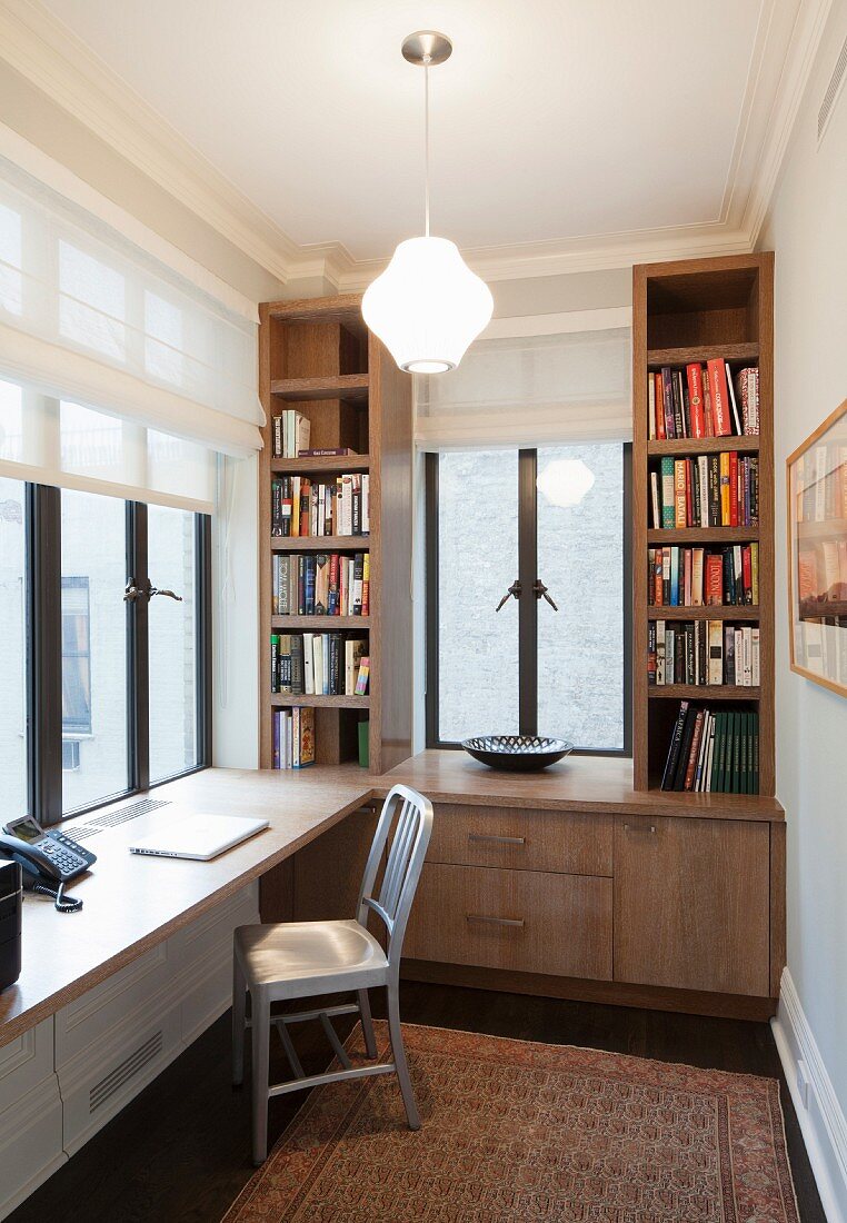 Custom fitted shelves and desk in small study