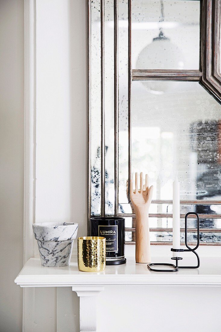 Marble pot and various vessels on mantelpiece