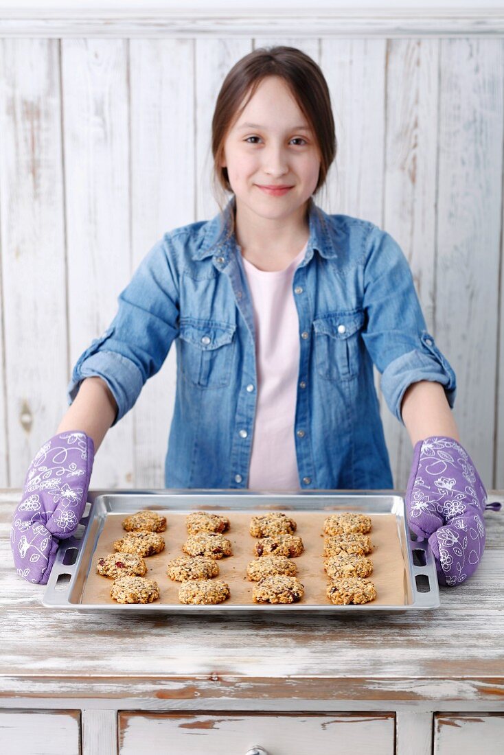 A girl with freshly baked muesli biscuits