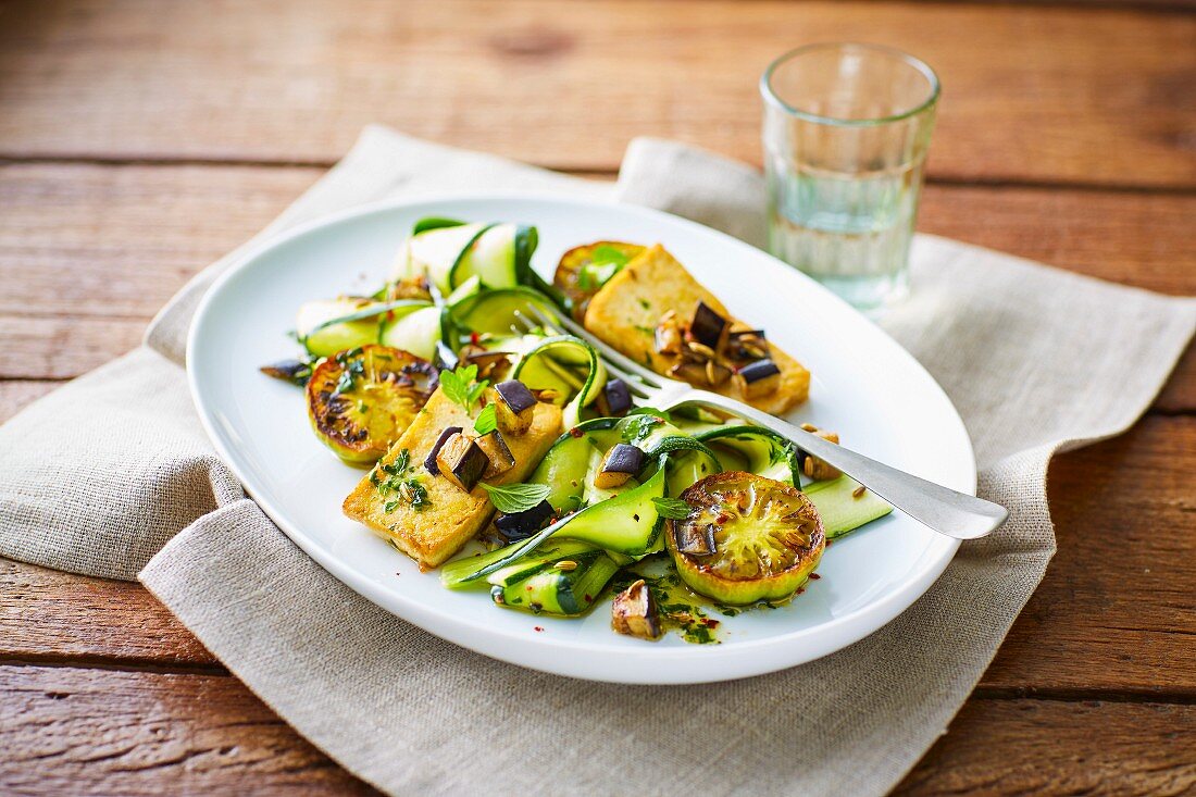 Vegan marinated courgette slices with tofu, aubergines and green tomatoes