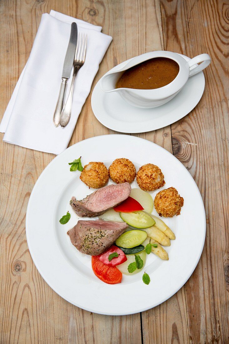 Pork fillet with vegetables and croquettes