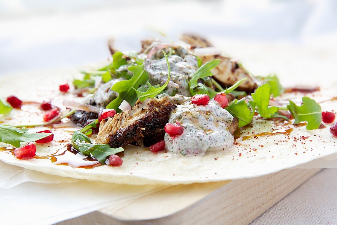 Persian chicken wraps with rocket and pomegranate