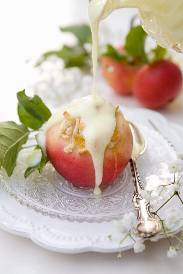 Oven-baked apples with almond cream, apricot jam and vanilla sauce