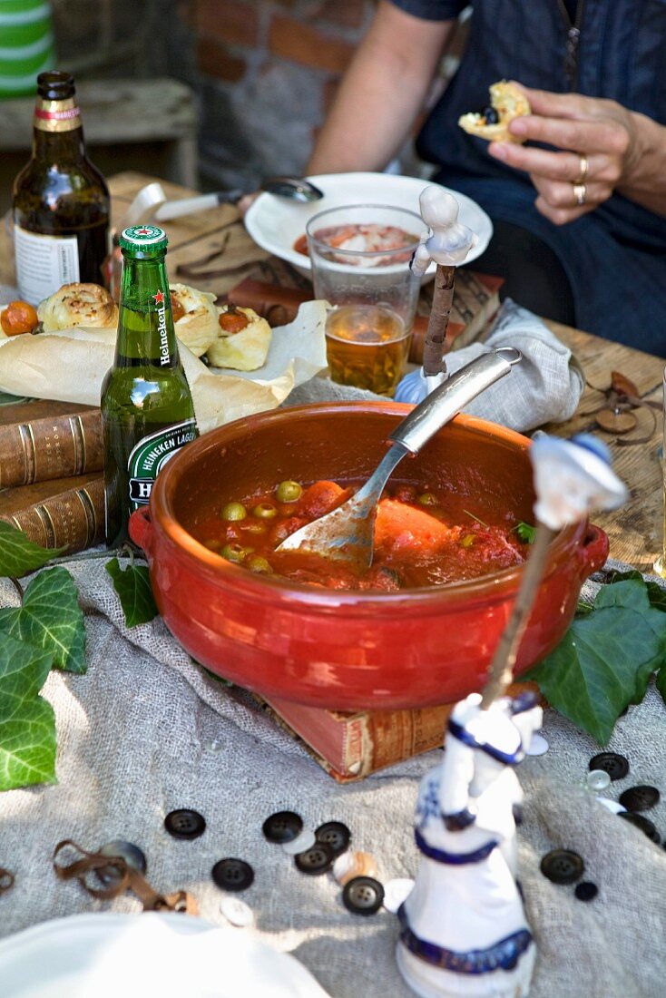 Tomato stew with crayfish on a laid table