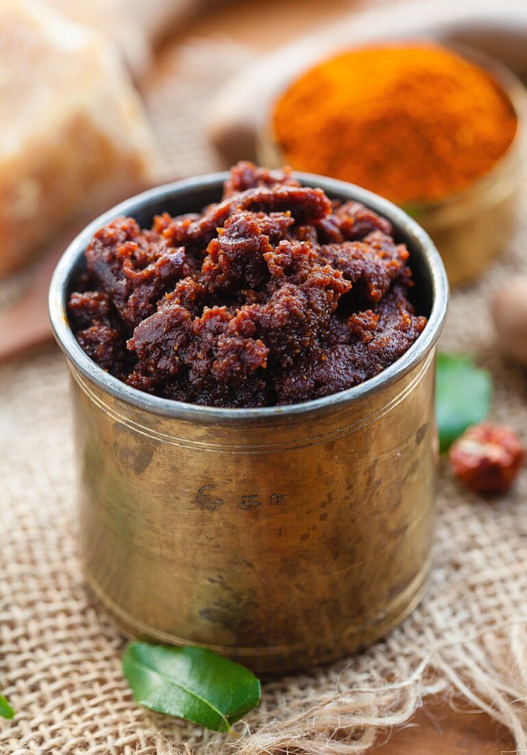 Tamarind chutney in a metal tin