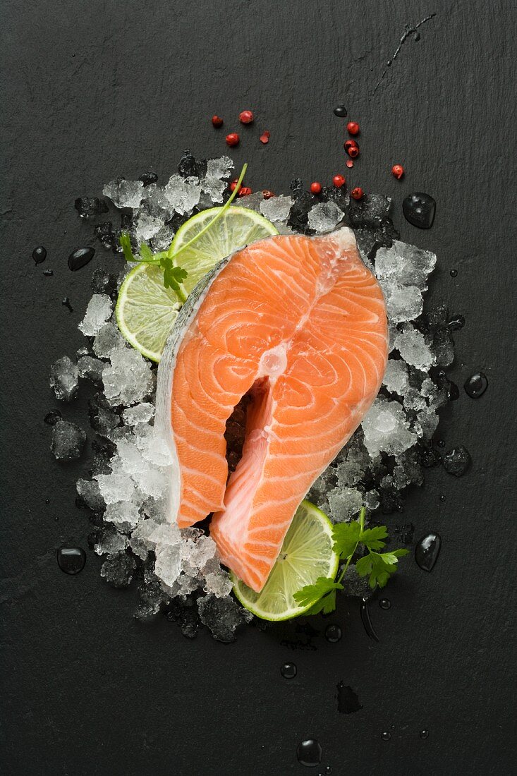Fresh salmon steak on crushed ice and lime slices