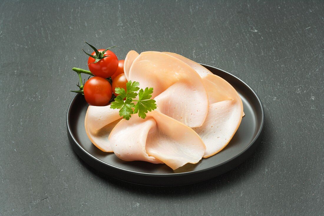 Turkey ham and cherry tomatoes on a plate