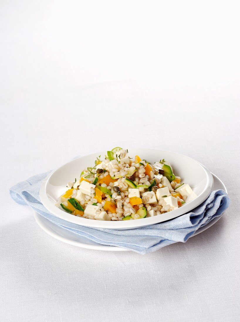Warm orzo salad with vegetables, herbs and cream cheese