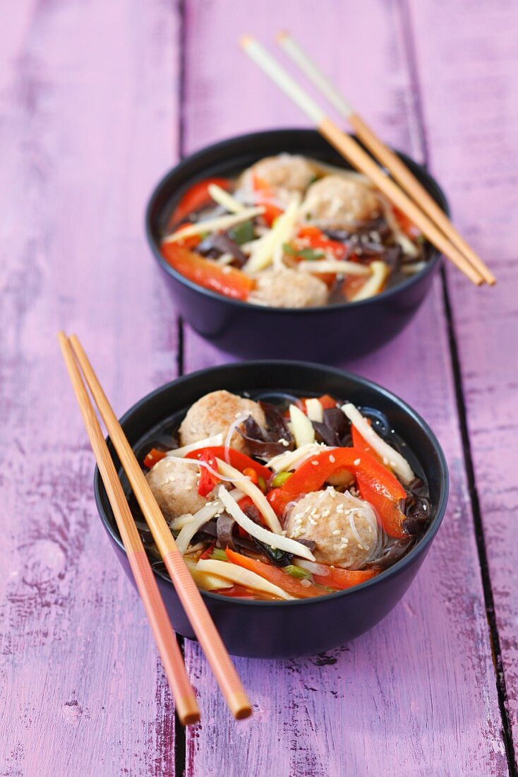 Broth with pork meatballs, Mu-Err mushrooms, bamboo shoots, rice noodles and peppers