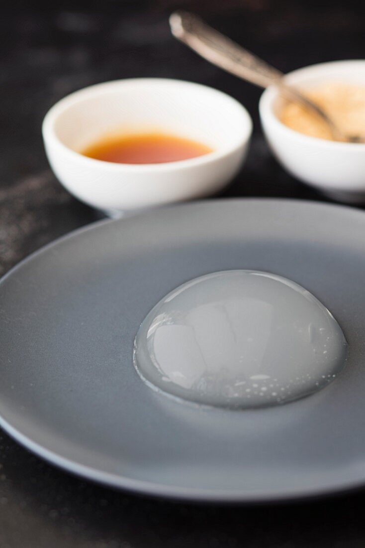 Mizu Shingen Mochi (Japanese raindrop cake) on a grey plate