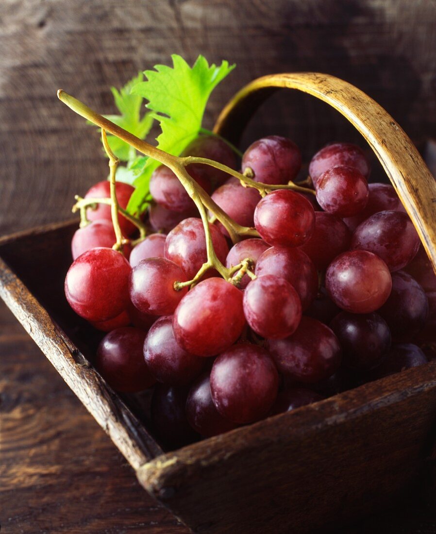 Red grapes in a vintage wooden basket