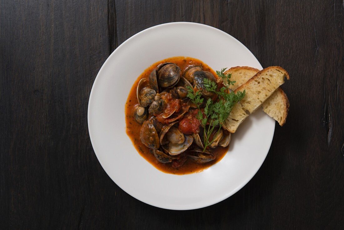 Clams in a spicy tomato broth with crostini