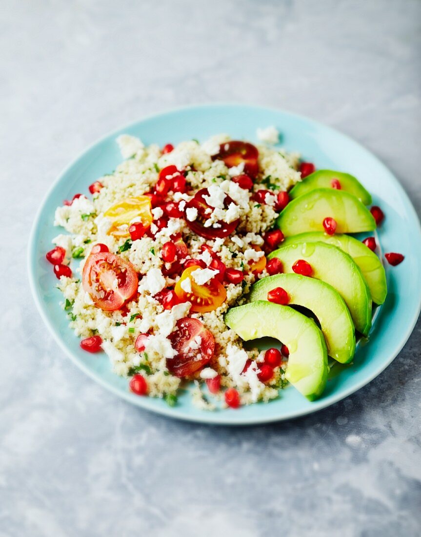 Bulgur salad with avocado, tomatoes, pomegranate seeds and feta cheese