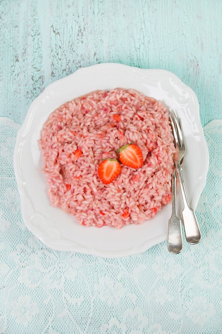 Strawberry rice pudding on a plate with cutlery